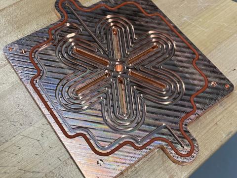 A copper heatsink used to cool flame nozzles.